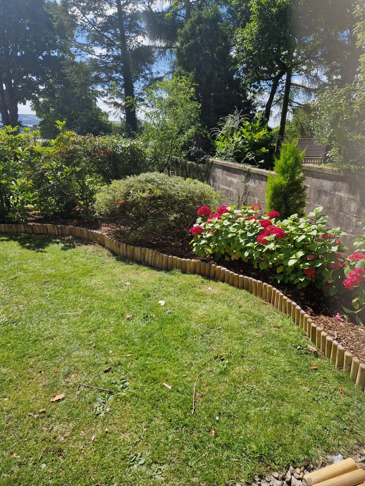 Fresh soft-landscaped garden with lawn, flower borders and clean edging in Perthshire
